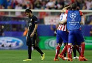 Barcelona's Neymar, left, leaves the pitch as Atletico players celebrate at the end of the Champions League quarterfinal second leg soccer match between Atletico Madrid and FC Barcelona in the Vicente Calderon stadium in Madrid, Spain, Wednesday, April 9, 2014. Atletico defeated Barcelona 1-0. (AP Photo/Paul White)
