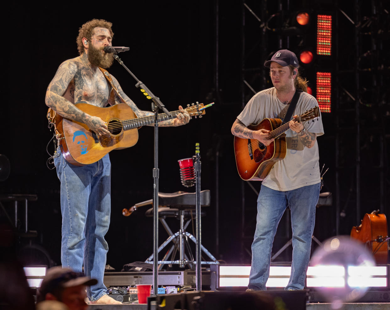 Malone and Billy Strings perform onstage.