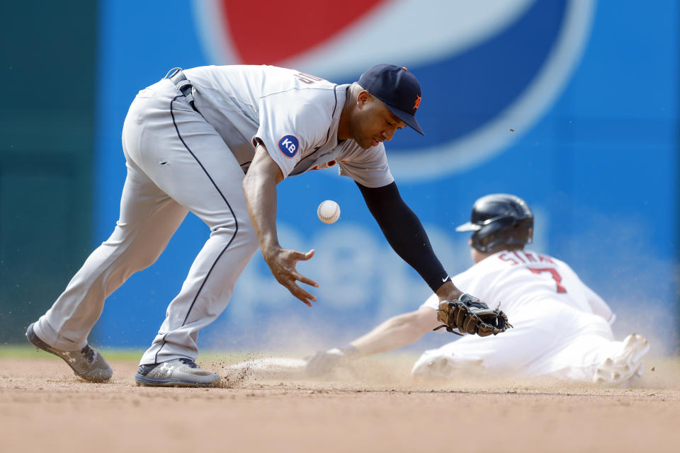 Detroit Tigers second baseman Jonathan Schoop tries to control the ball as Cleveland Guardians' Myles Straw steals second base during the fifth inning in the first baseball game of a doubleheader Monday, Aug. 15, 2022, in Cleveland. (AP Photo/Ron Schwane)