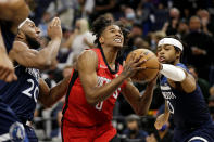 Houston Rockets guard Jalen Green drives on Minnesota Timberwolves forward Josh Okogie (20) and Timberwolves guard D'Angelo Russell, right, during the second half of an NBA basketball game Wednesday, Oct. 20, 2021, in Minneapolis. (AP Photo/Andy Clayton-King)