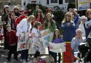 Race fans line the course near the start line of the 118th Boston Marathon Monday, April 21, 2014 in Hopkinton, Mass. (AP Photo/Steven Senne)