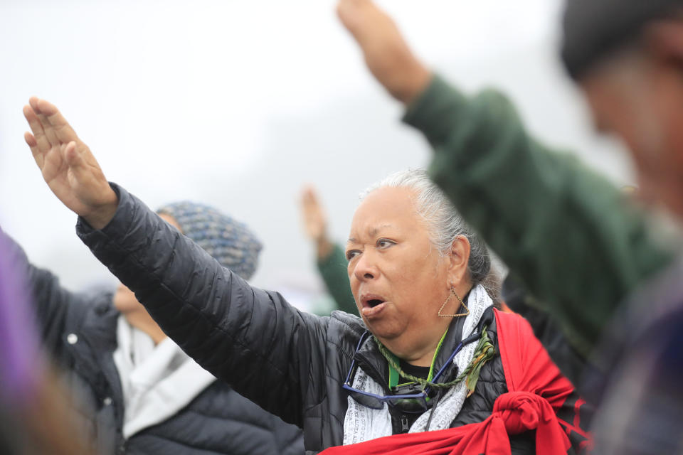 FILE - Kupuna Noe Noe Wong-Wilson dances a morning hula with other kupuna and ki'ai during the seventh day of protests against the TMT telescope on July 22, 2019 at the base of Mauna Kea on Hawaii Island. For over 50 years, telescopes have dominated the summit of Mauna Kea, a place sacred to Native Hawaiians and one of the best places in the world to study the night sky. That's now changing with a new state law saying Mauna Kea must be protected for future generations and that science must be balanced with culture and the environment. (Jamm Acquino/Honolulu Star-Advertiser via AP, File)