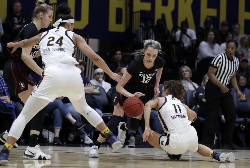 Stanford's Lexie Hull, center, controls the ball between California's Evelien Lutje Schipholt (24) and Sara Anastasieska (11) in the first half of an NCAA college basketball game Sunday, Jan. 12, 2020, in Berkeley, Calif. (AP Photo/Ben Margot)