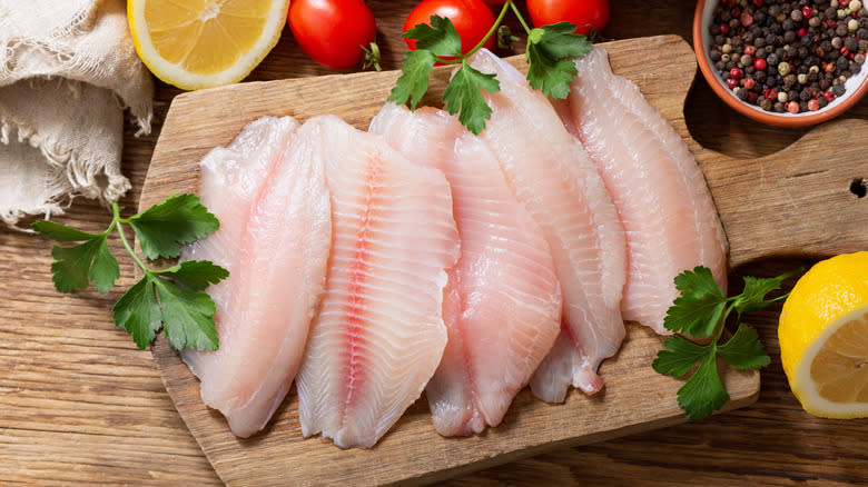 Fresh tilapia on a cutting board