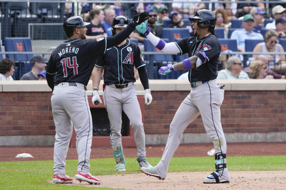 Arizona Diamondbacks' Ketel Marte, right, is greeted by Gabriel Moreno, left, after hitting a two-run homer during the ninth inning of a baseball game at Citi Field, Sunday, June 2, 2024, in New York. (AP Photo/Seth Wenig)