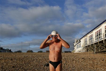 Graham prepares to swim in the sea at the seafront in Portsmouth November 25, 2013. The British shipbuilding industry has been through a turbulent time after defence contractor BAE Systems announced in November that it planned to lay off 1,775 ship workers across the UK. The cuts signal the end of more than 500 years of shipbuilding in Portsmouth on England's south coast. REUTERS/Stefan Wermuth