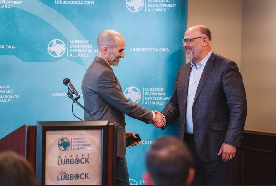 Elad Shmulevich (left), Dura-Line's vice president of operations, greets John Osborne, CEO and president of the Lubbock Economic Development Alliance, during a news conference Wednesday.