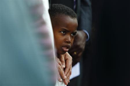 A young Sub-Saharan African migrant attends a commemorative service, organised by the Jesuit Refugee Services for immigrants who lost their lives at sea earlier this month, at Valletta's Grand Harbour, October 25, 2013. REUTERS/Darrin Zammit Lupi