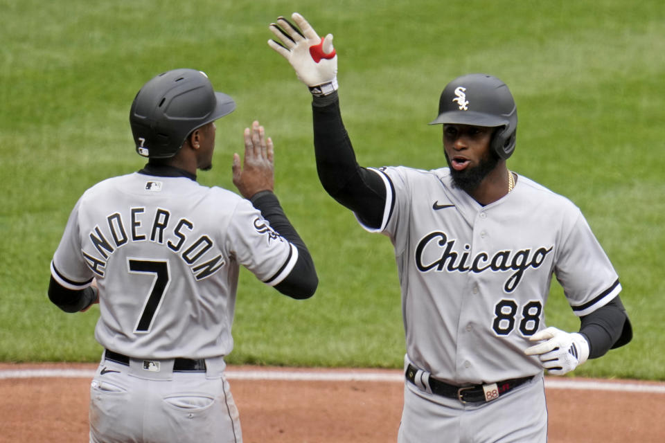 Chicago White Sox's Luis Robert Jr. (88) is greeted by Tim Anderson as he crosses home plate after hitting a two-run home run off Pittsburgh Pirates starting pitcher Rich Hill during the third inning of the Pirates home opener baseball game in Pittsburgh, Friday, April 7, 2023. (AP Photo/Gene J. Puskar)