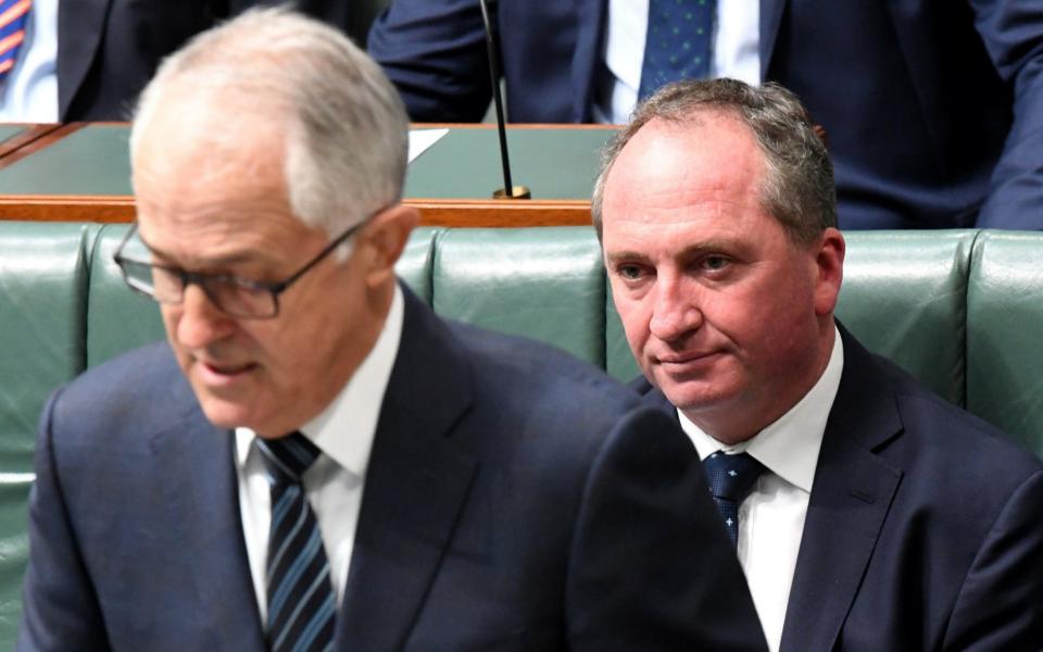 Barnaby Joyce reacts as Malcolm Turnbull  speaks at Parliament House in Canberra - AAP