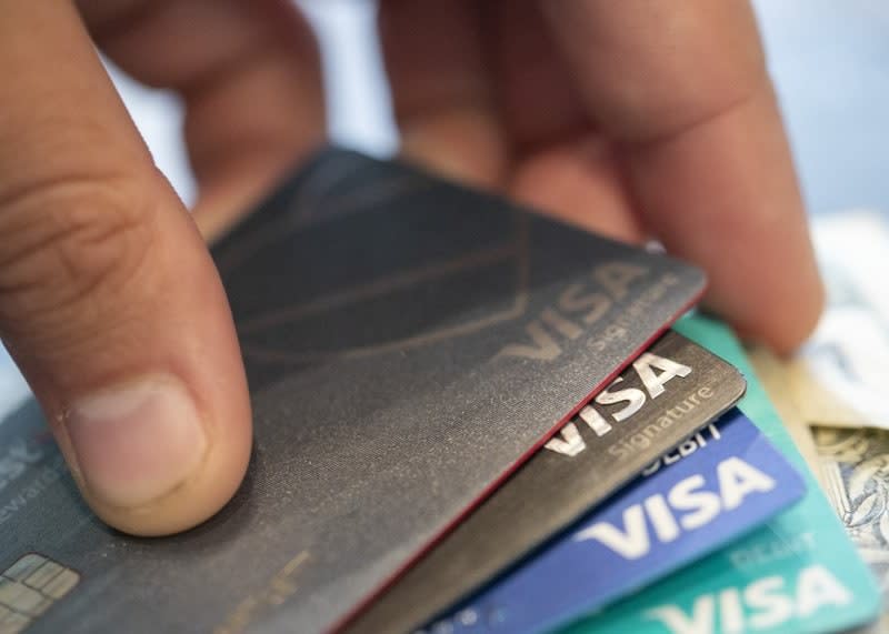 This Aug. 11, 2019 file photo shows Visa credit cards in New Orleans. U.S. consumers increased their borrowing in September 2020, helped by the first gain in the category that covers credit cards in seven months. (AP Photo/Jenny Kane, File)