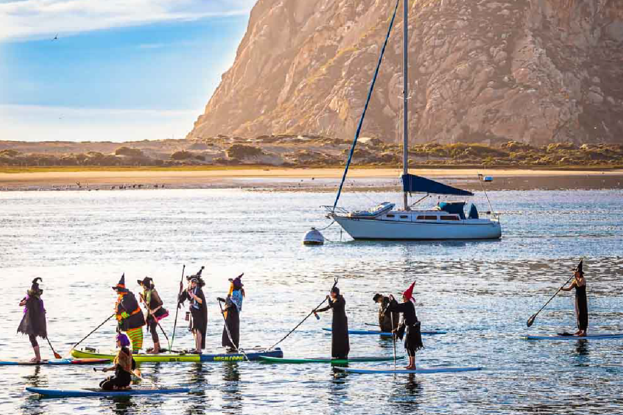 Paddleboarders and kayakers gathered in the waters of Morro Bay during the annual Witches and Warlocks Paddle.