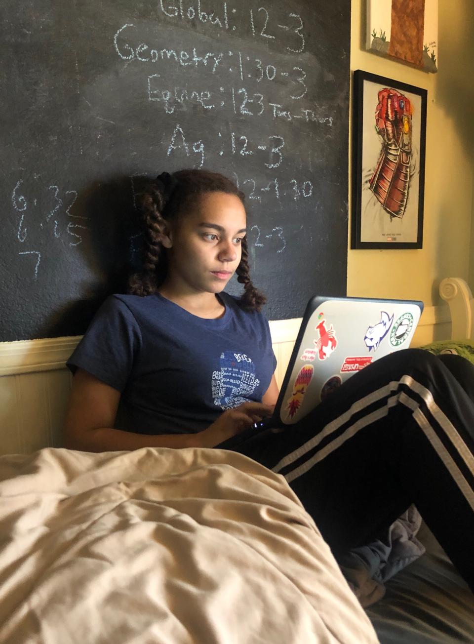 Ella Canady, 15, completes her school work online while at home in Phoenix, Arizona in April 2020. Like many teens, she's dealing with the stress of missing friends and rituals after schools shut down to contain the spread of the coronavirus.