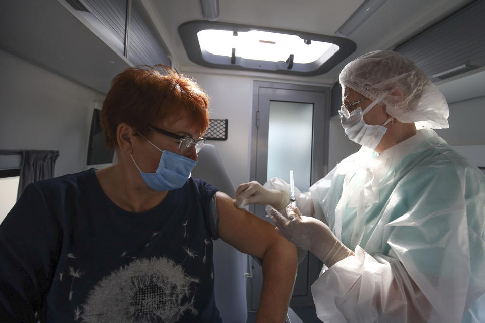 A medical staff member prepares to administer a dose of Russia's Sputnik V COVID-19 vaccine Sputnik V inside a mobile vaccination center in Krymsk, Krasnodar region, Russia, Friday, Oct. 29, 2021. Russia has recorded another record of daily coronavirus deaths even as authorities hope to stem contagion by keeping most people off work. Authorities have blamed soaring infections and deaths on Russia's lagging pace of vaccinations. About 51 million Russians — just over a third of the country's nearly 146 million people — were fully vaccinated as of Friday. (AP Photo/Vitaly Timkiv)