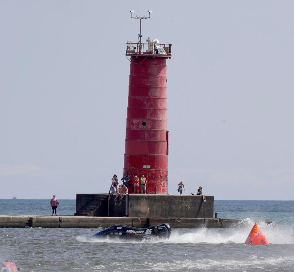 Mike Makus (85) rounds a buoy by the lighthouse during the Mercury Midwest Challenge, Saturday, August 12, 2023, in Sheboygan, Wis.