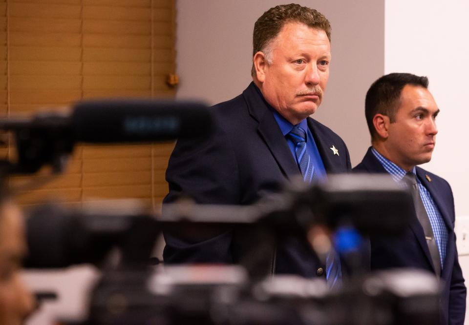 Lt. Mike Mongoluzzo, left, and Detective Ryan Stith listen to Sheriff Billy Woods on Tuesday during a press conference.