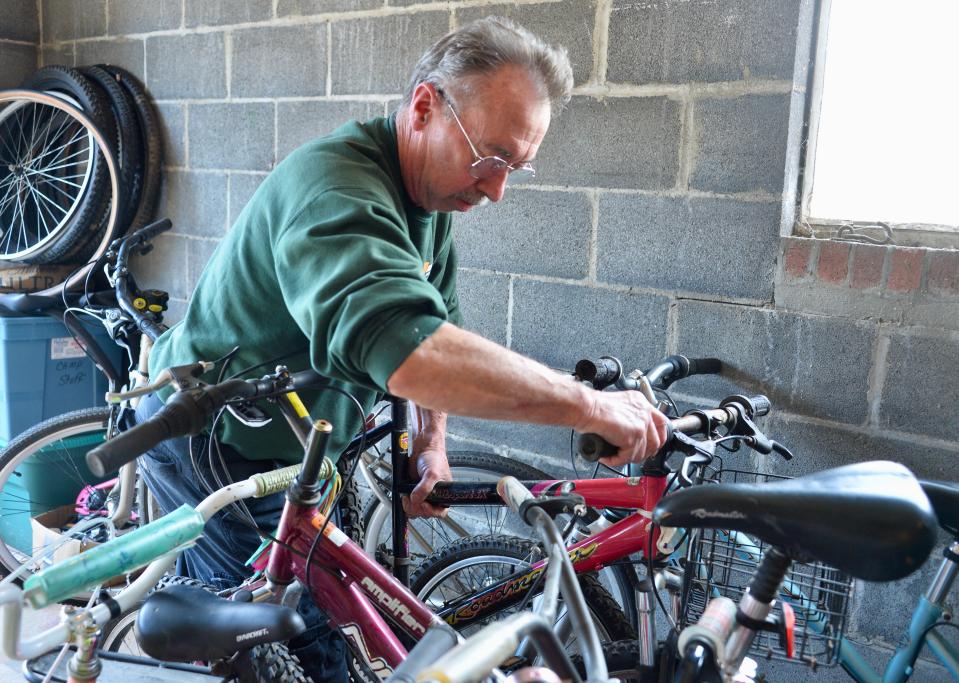 Bert Brittain with M.S. Johnston Co., on March 13, sorts through about 50 bikes being stored for Otterbein United Methodist Church's collection effort for Bikes for the World.