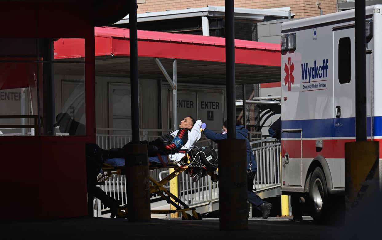 A person on a gurney is transported to Elmhurst Hospital Center on March 2, 2021 in New York City. (Angela Weiss/AFP via Getty Images)