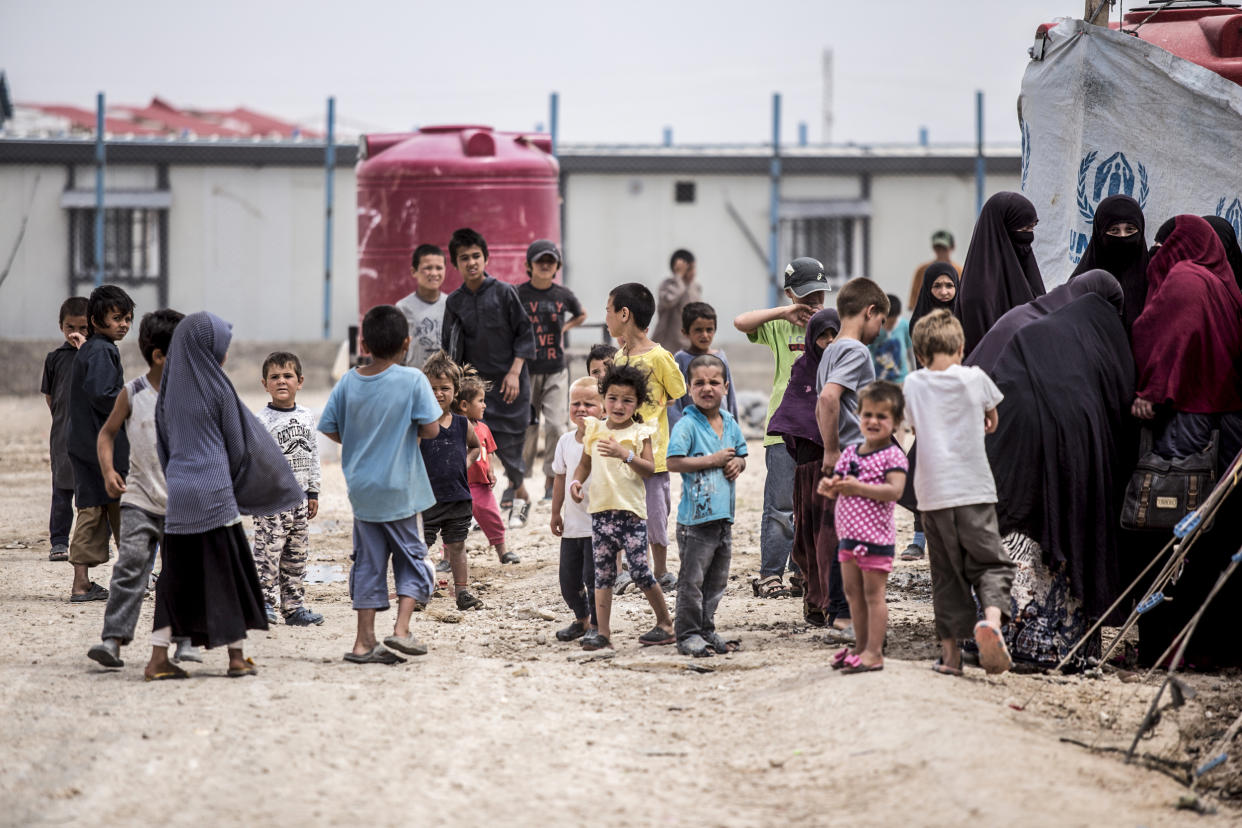 Women and children gather in front their tents at al-Hol camp in Hasakeh province, Syria, on May 1, 2021. (Baderkhan Ahmad / AP file)