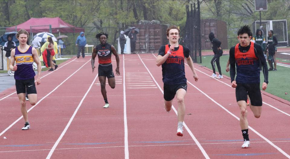 Horace Greeley's Niko Wright (r) beats teammate Seamus Finn to the finish during the boys 200-meter at  the Gold Rush Invitational Track and Field meet April 29, 2023 at Clarkstown South High School in West Nyack. Despite poor weather, Wright ran a personal-best 22.27 and took first out of 137 boys who ran the race in multiple heats.