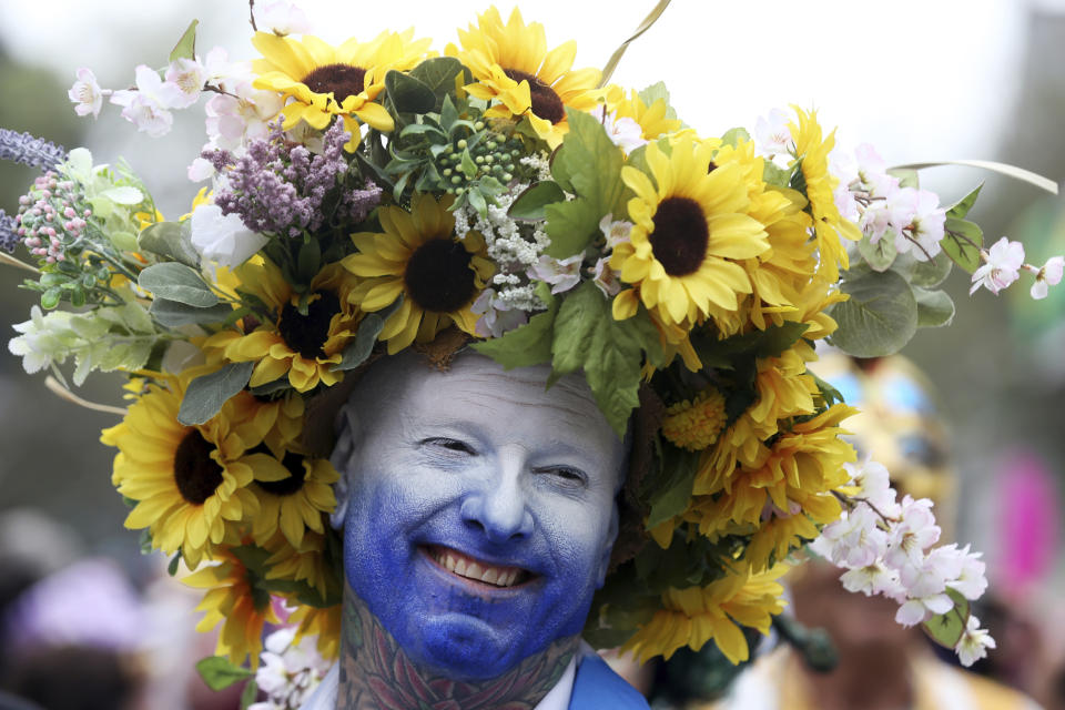 Andy Overslaugh is dress as "day" as he marches along with the Society of St. Anne on Royal Street on Mardi Gras day in New Orleans, Tuesday, Feb. 25, 2020. (AP Photo/Rusty Costanza)