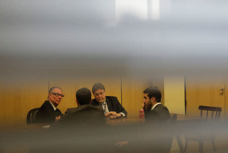 Brazilian Olympic Committee (COB) President Carlos Arthur Nuzman (L) talks with his lawyers before his hearing at the Federal Police headquarters in Rio de Janeiro, Brazil, September 5, 2017. REUTERS/Ricardo Moraes