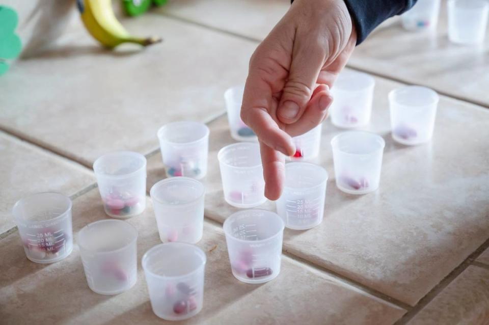 Summer Whitmore, Lance Petersen’s home-care provider, prepares Lance’s medication for the week last month. Lance takes a number of expensive medications to help with his autism spectrum disorder, bipolar disorder and attention-deficit/hyperactivity disorder.