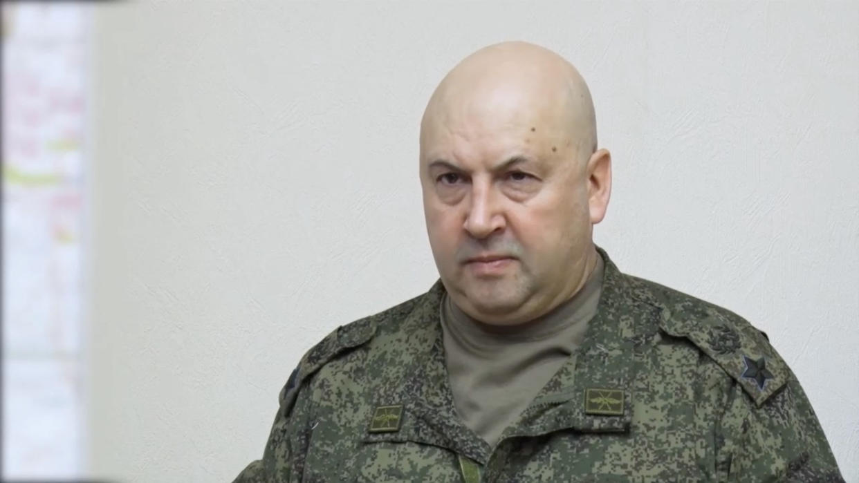 Gen. Sergey Surovikin, in battle camouflage, looks grim.