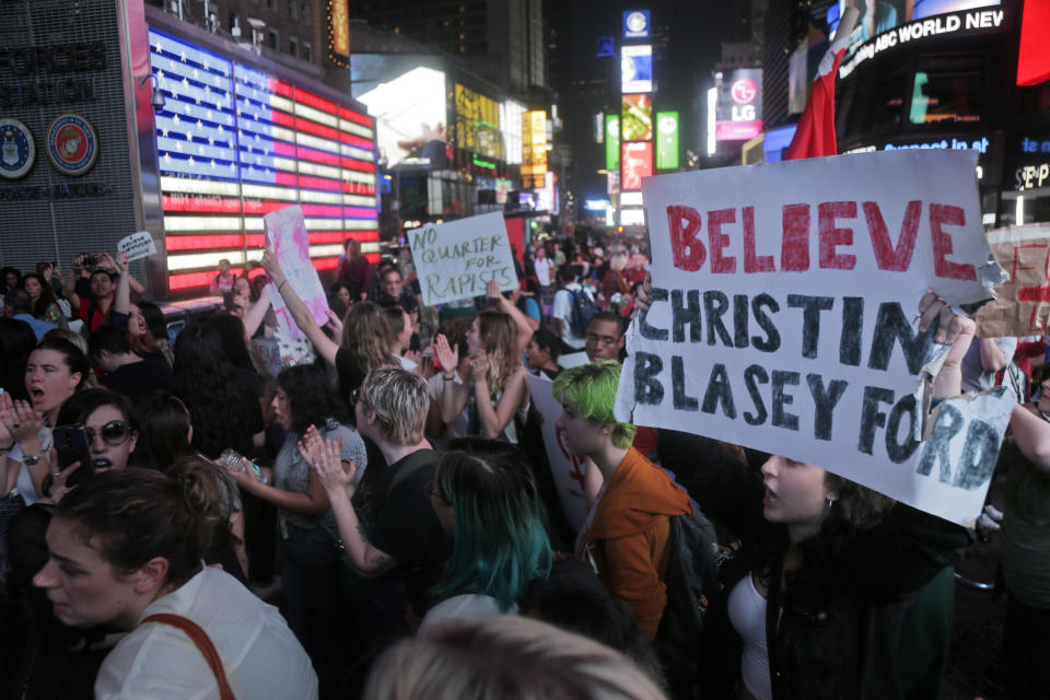Protesters rally in Time Square in New York, Thursday, Oct. 4, 2018. Hundreds of people rallied in front of Trump Tower then walked to Times Square to protest Supreme Court nominee Brett Kavanaugh. (AP Photo/Seth Wenig)