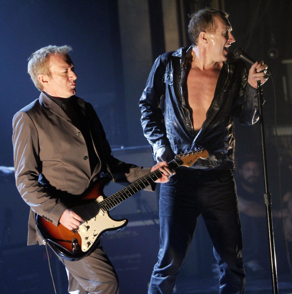FILE- In this Feb. 8, 2011, file photo, Gang of Four's guitarist Andy Gill, left, and singer Jon King perform a concert at Webster Hall in New York. Gill, who led the highly influential British post-punk band Gang of Four, died Saturday, Feb. 1, 2020, in London, according to a statement from the band. He was 64. (AP Photo/Jason DeCrow, File)