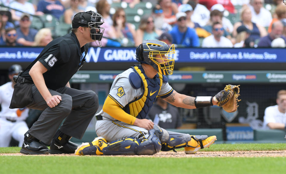 MLB umpire Clint Vondrak and Gary Sanchez of the Milwaukee Brewers crouch behind home plate and wait for a pitch during the game against the Detroit Tigers earlier this month. 