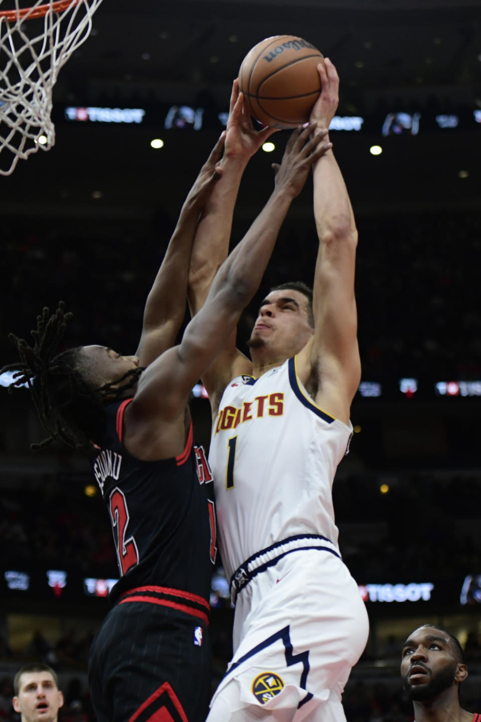 Denver Nuggets' Michael Porter Jr. (1) goes up to shoot against Chicago Bulls' Ayo Dosunmu (12) during the first half of an NBA basketball game Sunday, Nov. 13, 2022, in Chicago. (AP Photo/Paul Beaty)