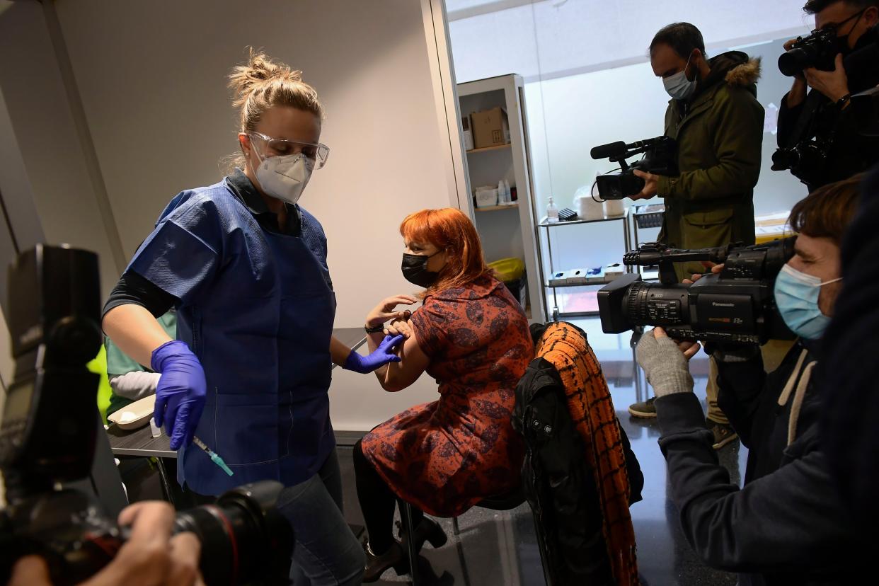 A health worker is vaccinated against the coronavirus in Pamplona, northern Spain, Tuesday, Dec. 29. 2020. Spain plans to receive over 4.5 million doses of the vaccine over the next three months, enough it says to immunize just over 2.2 million people. The government estimates that this first phase will be enough to cover nursing home residents and workers, followed by health workers in general and people with disabilities.