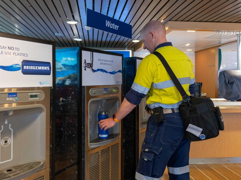 person refilling water bottle