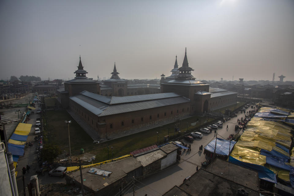 Kashmiris walk through a market outside the Jamia Masjid, or the grand mosque in Srinagar, Indian controlled Kashmir, Nov. 12, 2021. The mosque has remained out of bounds to worshippers for prayers on Friday – the main day of worship in Islam. Indian authorities see it as a trouble spot, a nerve center for anti-India protests and clashes that challenge New Delhi’s sovereignty over disputed Kashmir. For Kashmiri Muslims it is a symbol of faith, a sacred place where they offer not just mandatory Friday prayers but also raise their voice for political rights. (AP Photo/Mukhtar Khan)