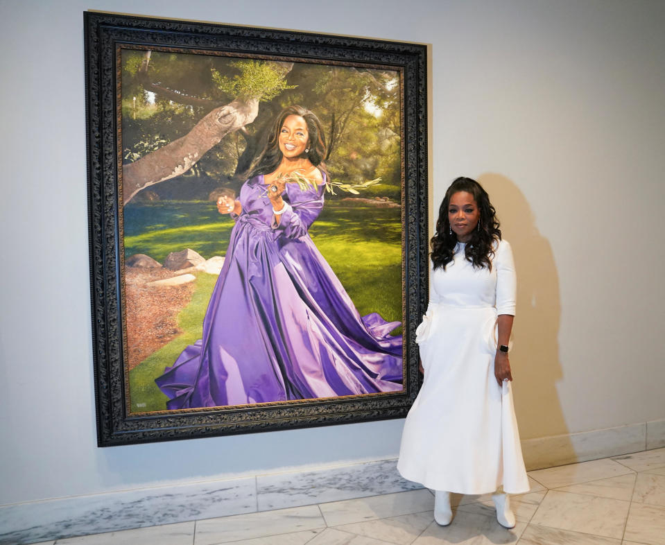 American television mogul Oprah Winfrey poses with her portrait after it was hung at Smithsonian's National Portrait Gallery in Washington, U.S., December 13, 2023. / Credit: KEVIN LAMARQUE / REUTERS