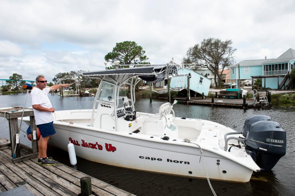 Michael Choron surveys the damage in the canal behind his home in Perdido Key, Fla., on Thursday, Sept. 17, 2020. Hurricane Sally made landfall as a Category 2 early Wednesday morning.