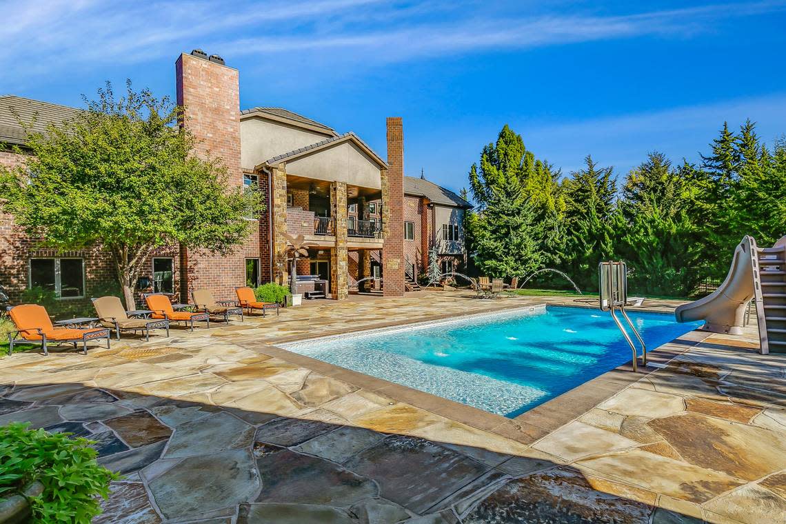 The yard of this $2,150,000 home includes a swimming pool, pool house, sports court and playground.