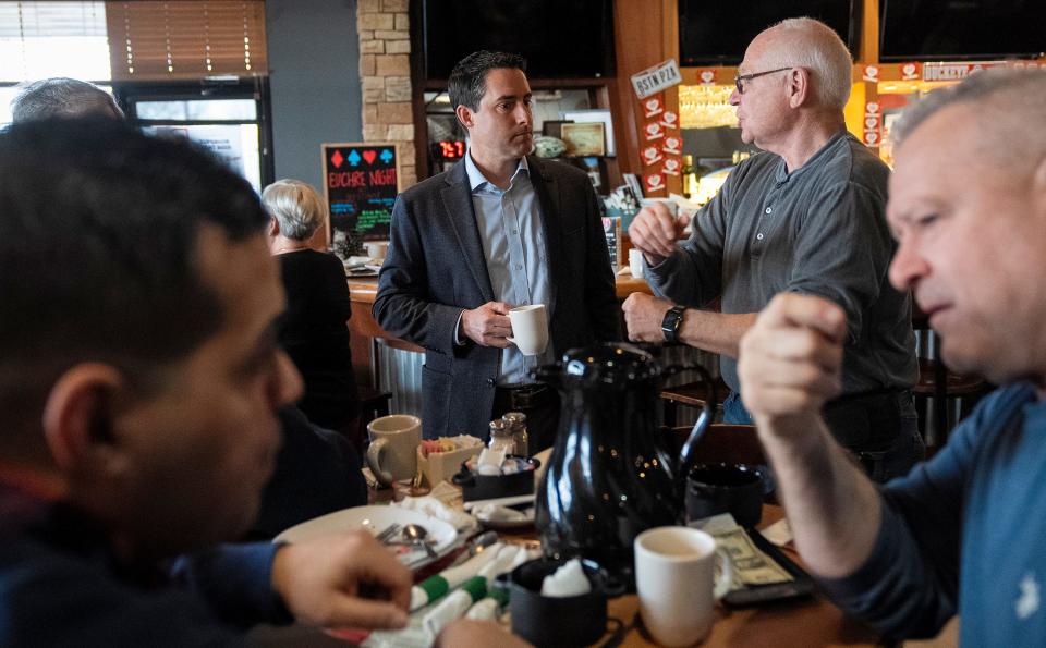 Jeff Robinson holds campaign materials for Frank LaRose during an event at Boston's Restaurant and Sports Bar in Marysville on Feb. 2.