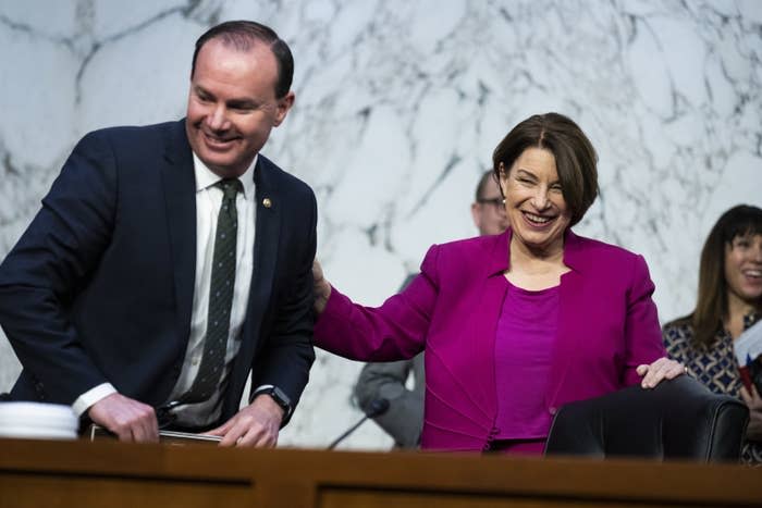 Sen. Amy Klobuchar greets Sen. Mike Lee during the Senate Judiciary Committee on Jan. 24.