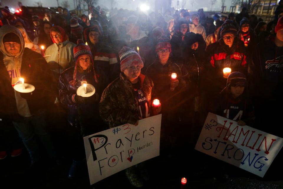Buffalo Bills fans and community members gather for a candlelight vigil for Bills safety Damar Hamlin on Tuesday in Orchard Park, N.Y.