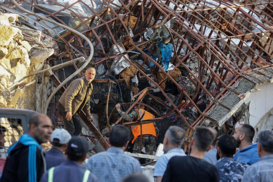 Emergency and security personnel inspect the rubble at the site of strikes which hit a building next to the Iranian embassy in Syria's capital Damascus (AFP via Getty Images)
