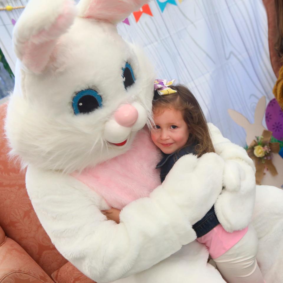 Rowan St. Clair ,4, of Conyngham, Pa., hugs the Easter Bunny before posting to have her picture taken with him at the Penn State University Hazleton campus in Hazleton, Pa., on Wednesday April 6, 2022.