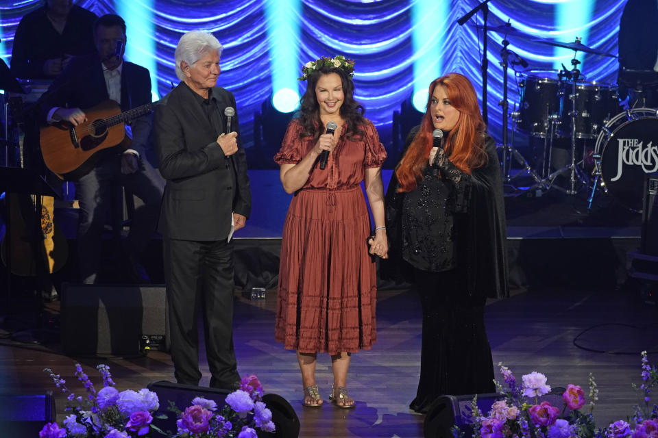 Larry Strickland, left, husband of Naomi Judd; Ashley Judd, center; and Wynonna Judd speak during a tribute to country music star Naomi Judd Sunday, May 15, 2022, in Nashville, Tenn. Naomi Judd died April 30. She was 76. (AP Photo/Mark Humphrey) - Credit: AP