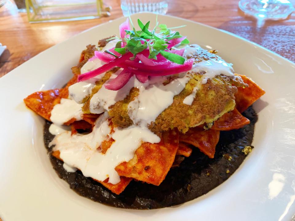 Vegan chilaquiles at The Coronado come on refried black beans with a tofu scramble.