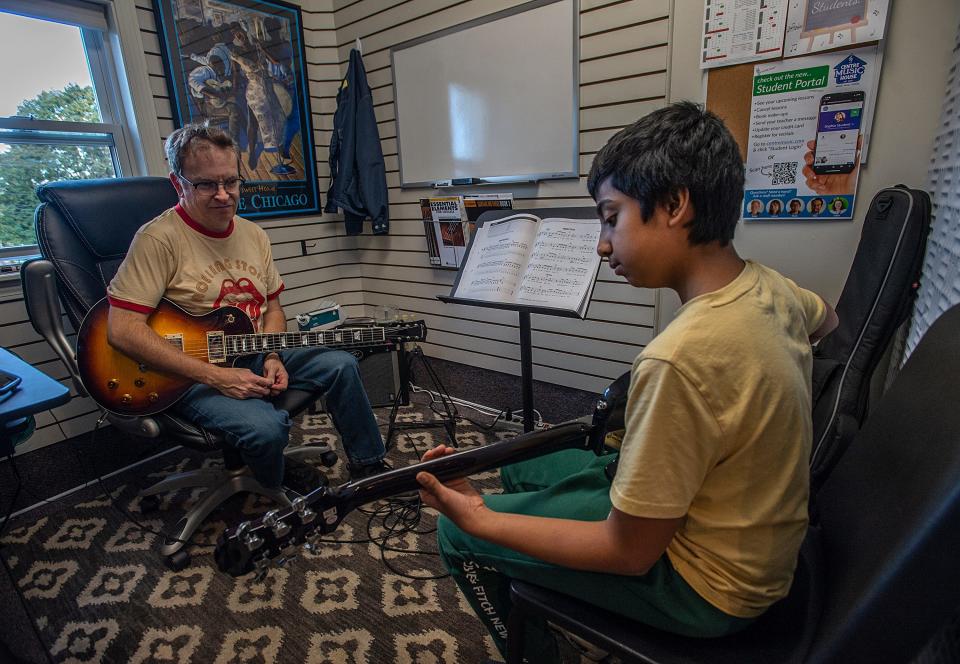 Ryan Oza, 12, of Hopkinton, takes pointers from guitar instructor Ryan Fleming while performing a song from Bon Jovi at Centre House Music in Framingham, Oct. 13, 2023.