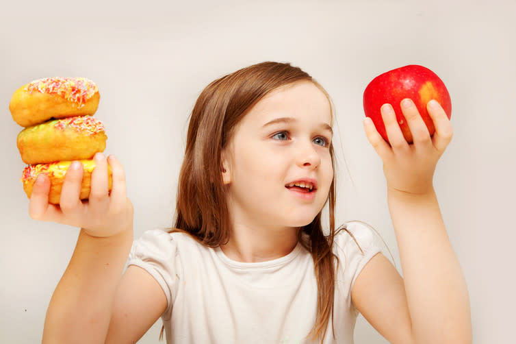 <span class="caption">Donuts or an apple? Financial incentives could make the answer easier.</span> <span class="attribution"><a class="link " href="https://www.shutterstock.com/image-photo/young-girl-enjoys-sandwich-consisting-wholemeal-93698170" rel="nofollow noopener" target="_blank" data-ylk="slk:Shutterstock;elm:context_link;itc:0;sec:content-canvas">Shutterstock</a></span>