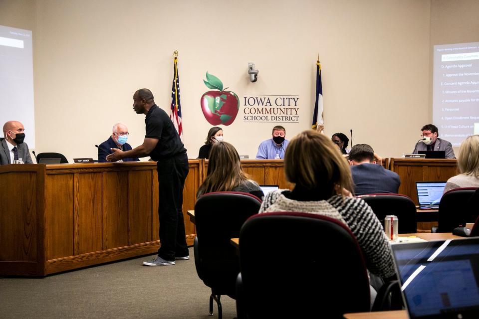 Rev. Doyle Landry speaks to Matt Degner, superintendent of the Iowa City Community School District, far left, during a meeting, Tuesday, Nov. 23, 2021, at the district's Educational Services Center (ESC) at 1725 North Dodge Street in Iowa City, Iowa.