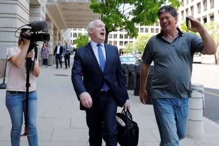 Lawyer Eric Dubelier reacts to a journalist's questions as he leaves U.S. District Court, following the arraignment of Concord Management and Consulting LLC, one of three entities and 13 Russian individuals indicted in an alleged criminal and espionage conspiracy to tamper in the 2016 U.S. presidential election, in Washington, U.S., May 9, 2018. REUTERS/Yuri Gripas