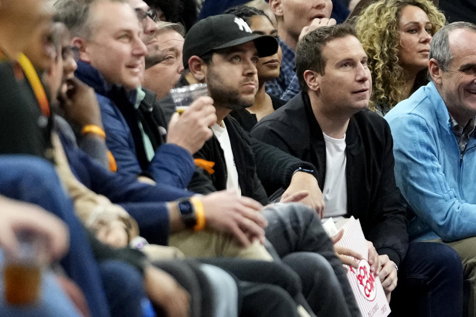 Incoming Phoenix Suns owner Mat Ishbia, right, watches during the first half of an NBA basketball game against the Brooklyn Nets, Thursday, Jan. 19, 2023, in Phoenix. (AP Photo/Matt York)